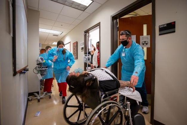 Nursing students working with simulation lab equipment.